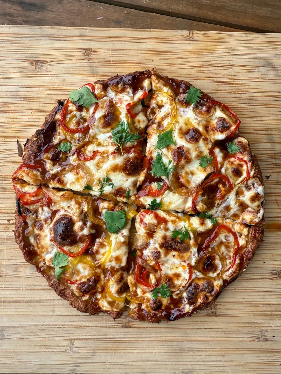 Pizza with barbecue sauce, browned mozzarella, sweet peppers, onion and cilantro