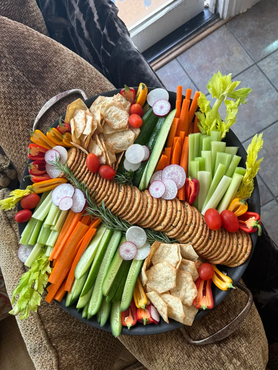 Round platter of carrot, celery, cucumber, radish, sweet peppers, tomatoes and crackers