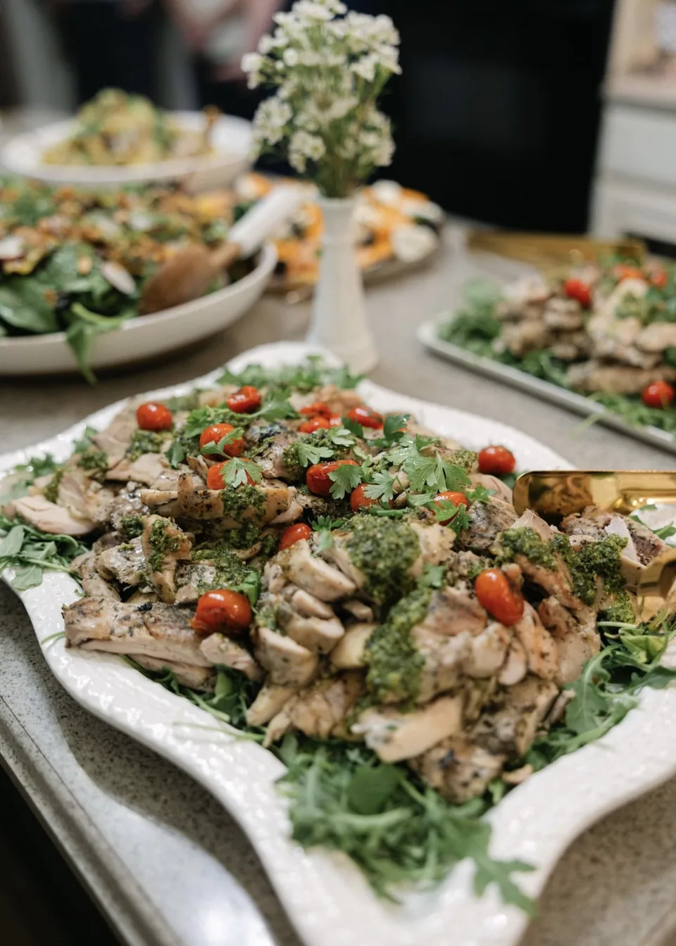 Party platter of grilled chicken with pesto and blistered tomatoes