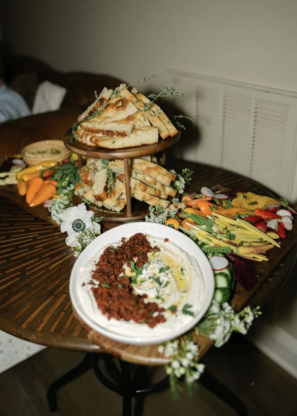 Grazing spread with stacked rosemary focaccia, a whipped dip topped with crispy chorizo, and crudité